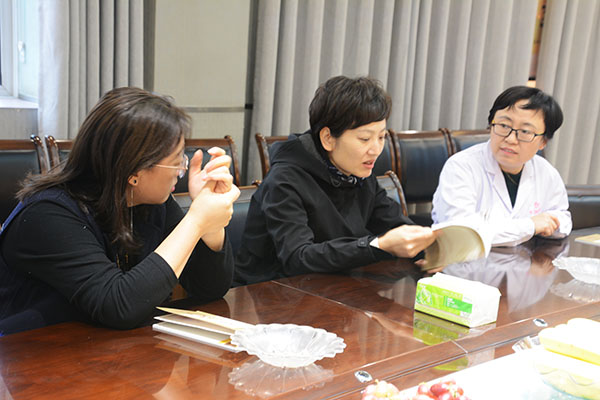 王芳副主任翻阅《结核病康复手册》